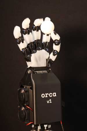 a picture of a robotic hand, holding a ping-pong ball